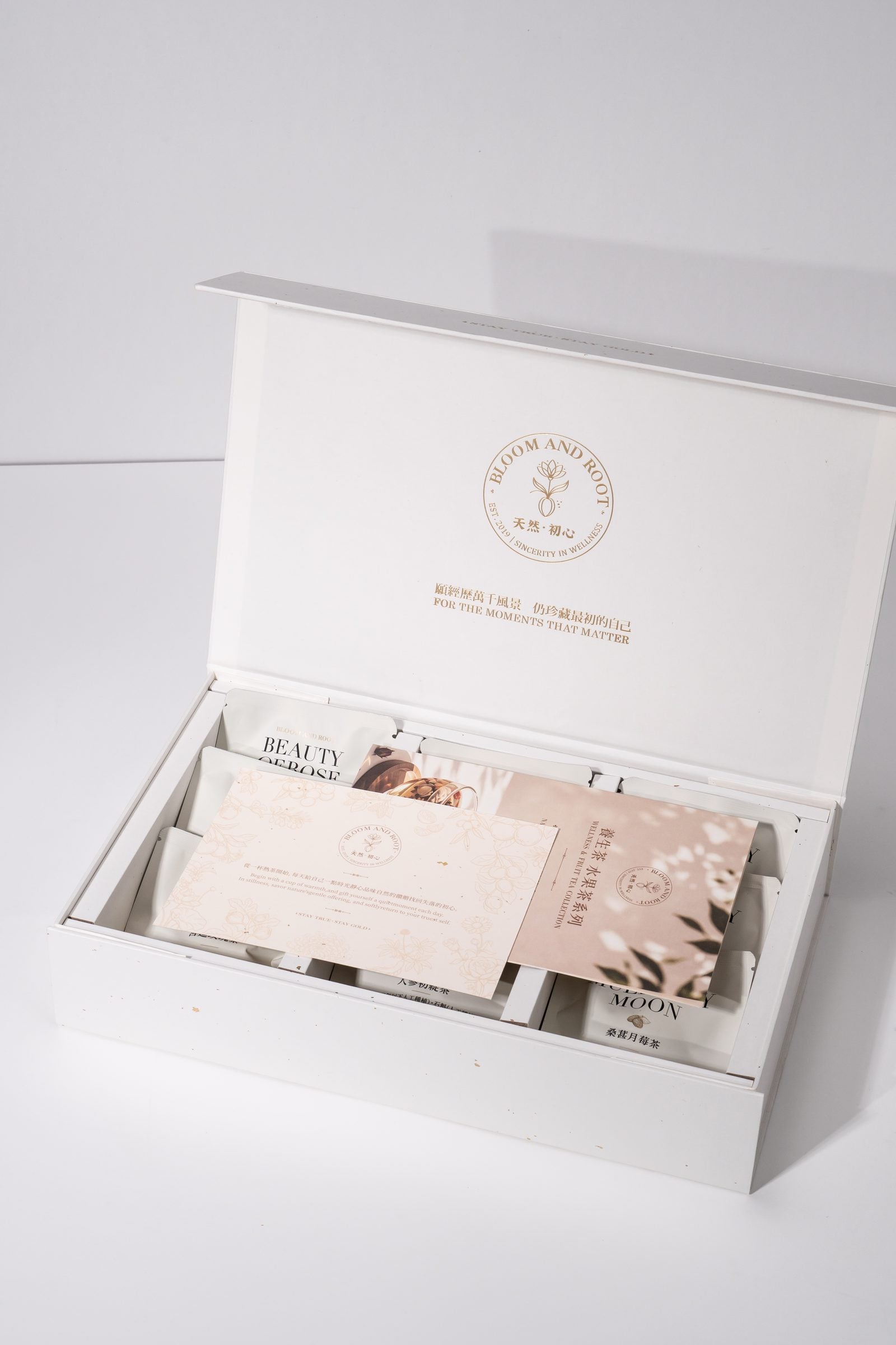 Bloom and Root gift box open, showing tea sachets and gift cards inside